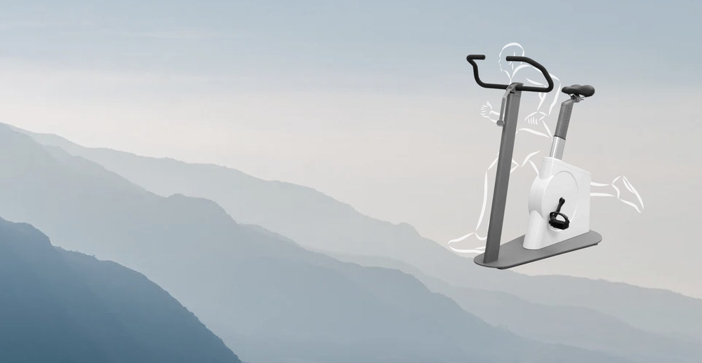 Fahrradergometer mit gezeichneter Läuferfigur vor einer Berglandschaft